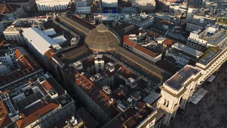 aerial view at sunset of milano duomo square cathedral downtown with vittorio emanuele gallery , drone top down cityscape