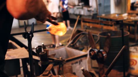 glassblower shaping a molten glass