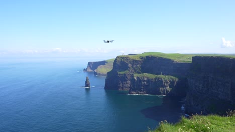 static shot of a drone ready to start flying over the famous cliffs of moher, ireland