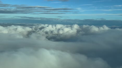 pov flying over the clouds with madrid city at the back