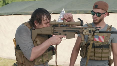 us military men looking through rifle scope