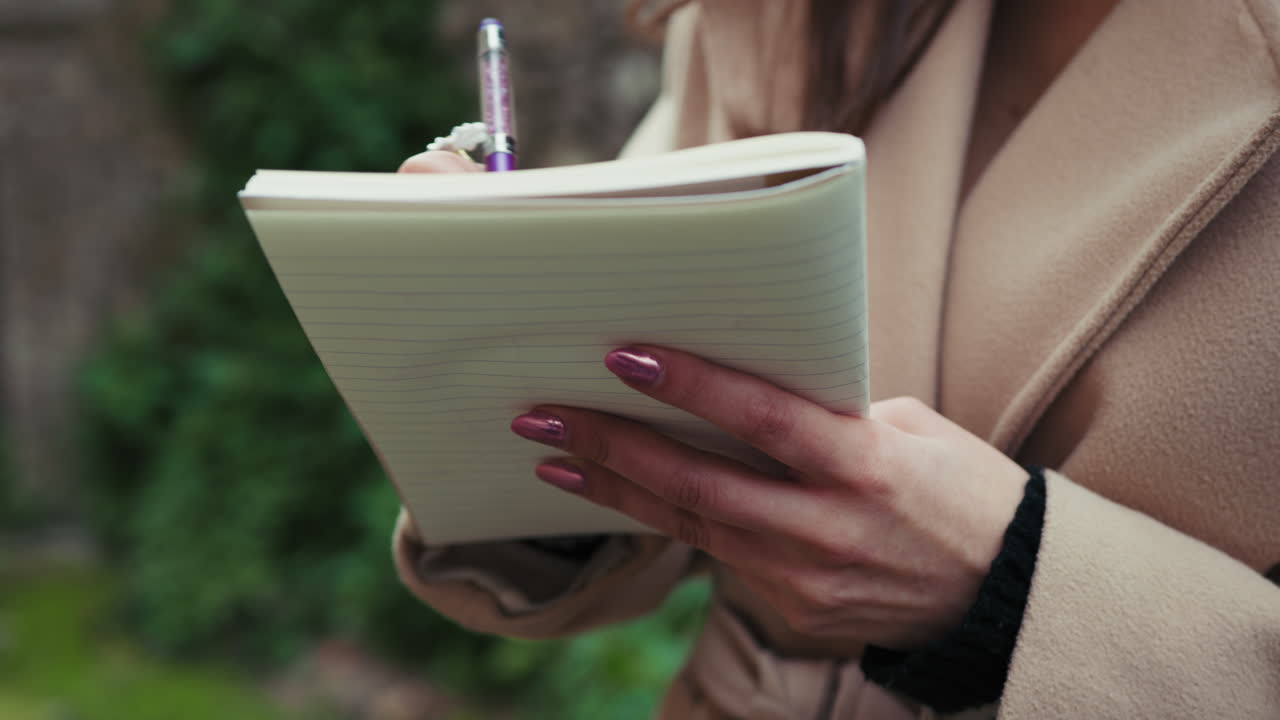 Details Of A Woman Hands Outdoor Taking Notes On The Notebook