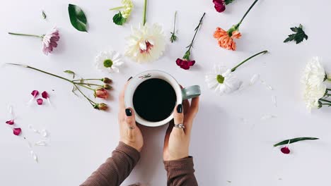 woman enjoying coffee with flowers