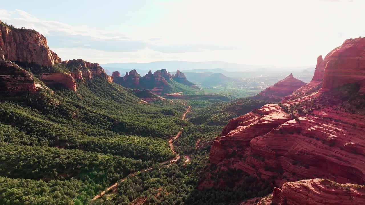 dolly aéreo por encima de merry ir alrededor de la roca, sedona arizona, sendero a través del valle