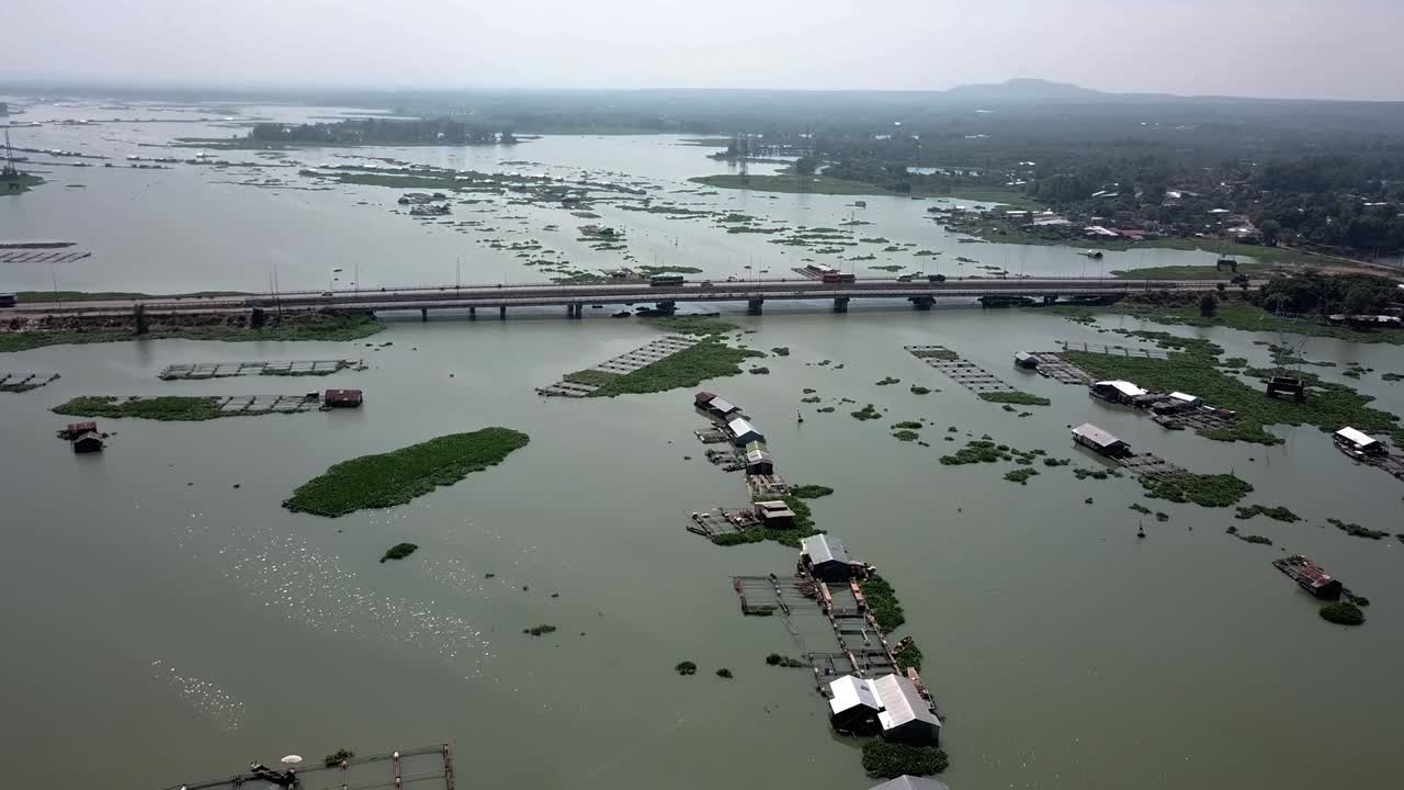 Aerial View of a River with Houses and Fish Farms