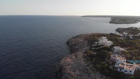 Aerial-view-of-Mallorca-Island-coastline-above-cliffs-and-pool-houses