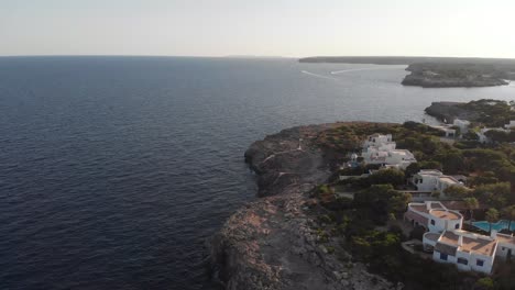 aerial view of mallorca island coastline above cliffs and pool houses