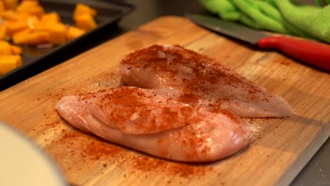 chicken being seasoned 4k