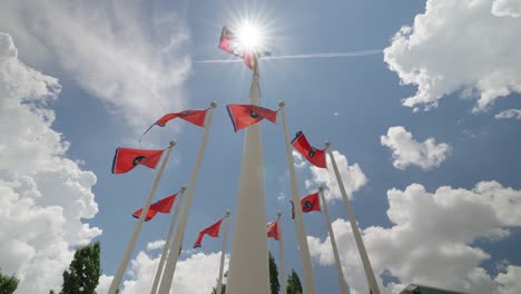 tennessee state flags waving in the wind on flagpoles in a park in nashville