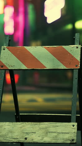 a close up of a red and white construction barrier at night