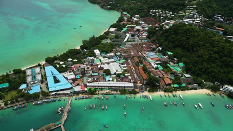 Cruise-and-Longtail-boats-at-the-Ferry-terminal-of-Kho-Phi-Phi-Island,-Thailand,-Aerial-View