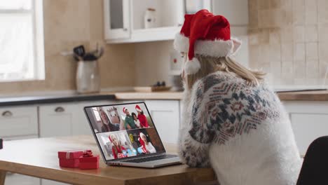 Caucasian-woman-having-a-christmas-video-call-with-family