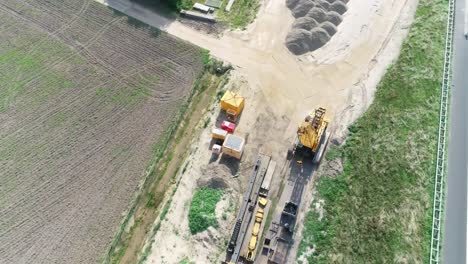 Aerial-drone-shot-of-machines-on-a-construction-site