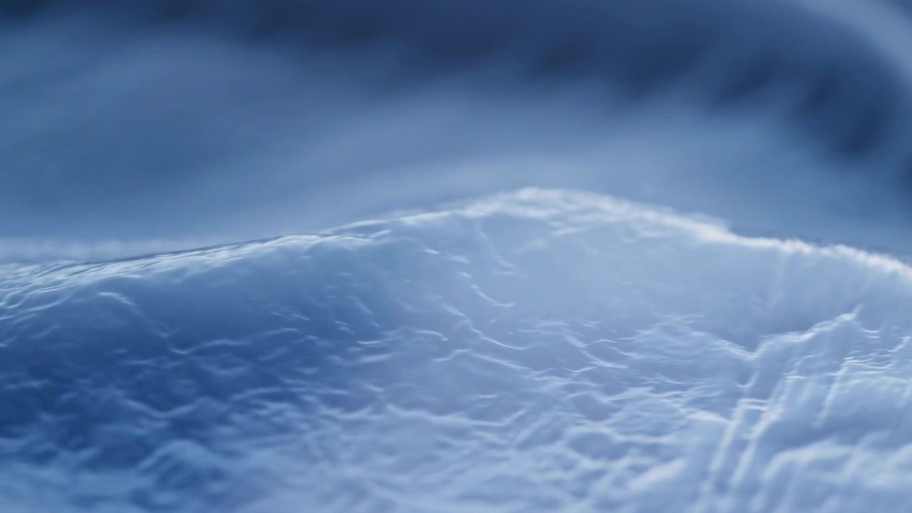 Close-up of a smooth blue frozen surface with fine ripples and soft light, fading into a blurred cool-toned background for a calm winter mood