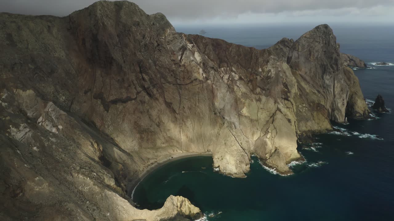 Spectacular view of volcanic cliffs with blue Atlantic ocean water, aerial