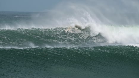 surfers paddle over huge wave and bail