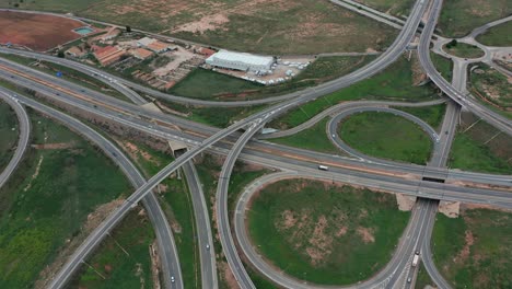 aerial drone accent large road intersection highway from high altitude, modern city traffic car move
