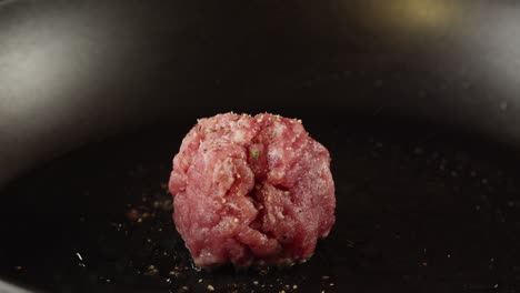 preparing a meatball in a pan