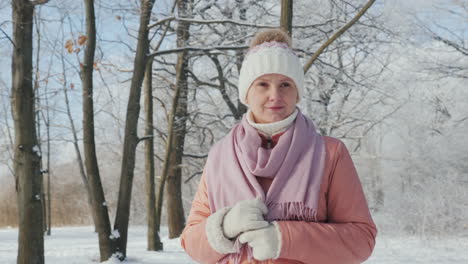 happy young woman is walking in the winter forest a beautiful clear day the branches of trees are co