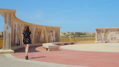 female tourist walking towards frescos, mural painting in basilica of the national shrine of the blessed virgin of ta' pinu in gharb, malta