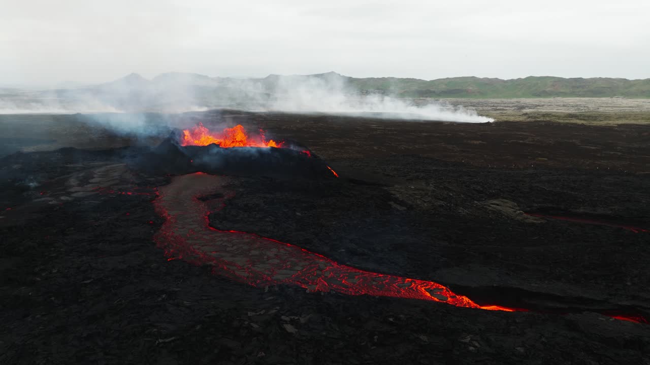 Aerial landscape view over the volcano erupting at Litli-Hrutur, Iceland, with lava and smoke coming up