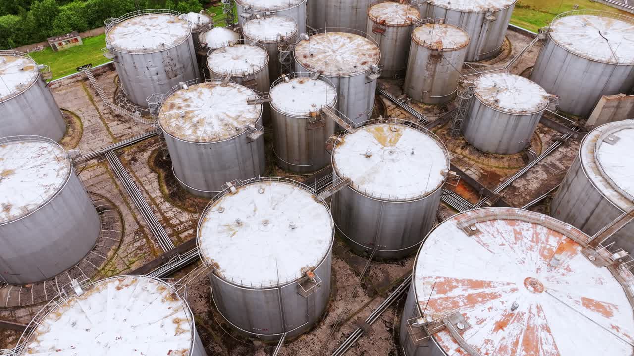 Rusty industrial storage containers seen from above, cinematic drone movement