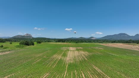 drone flying over a green field, mapping crops with advanced sensors in sunny weather