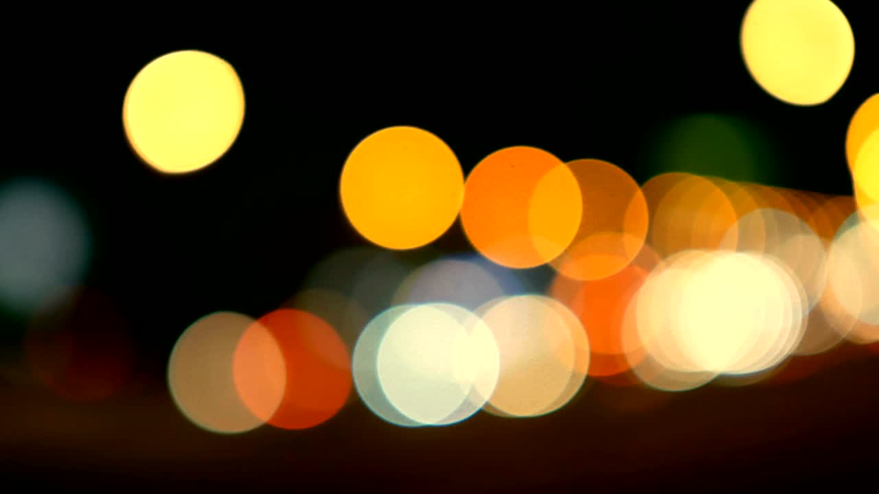luces desenfocadas calle de los ángeles resumen. fondo borroso de la ciudad. círculos de bokeh en movimiento del tráfico nocturno.
