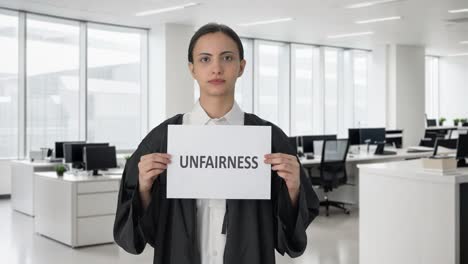 sad indian female lawyer holding unfairness banner