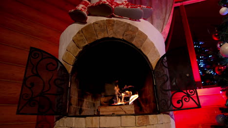 Fireplace interior at home in Christmas time. Beautiful fireplace in country house. Background for the design of New Year's greetings. Warmth and comfort at home at winter holidays.