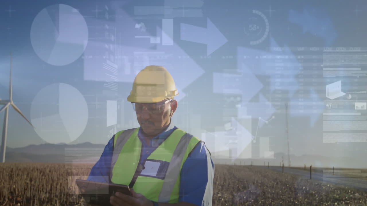 Field technician using tablet on wind farm, monitoring energy data with animated charts and arrows