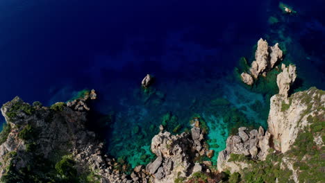 Top-down-aerial-drone-view-of-the-picturesque-rocky-coastline-of-Paleokastritsa-in-Corfu,-Greece