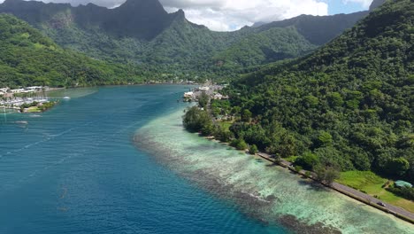 moorea island, french polynesia. aerial view of coastal road, coral reefs, harbor and landscape, panorama