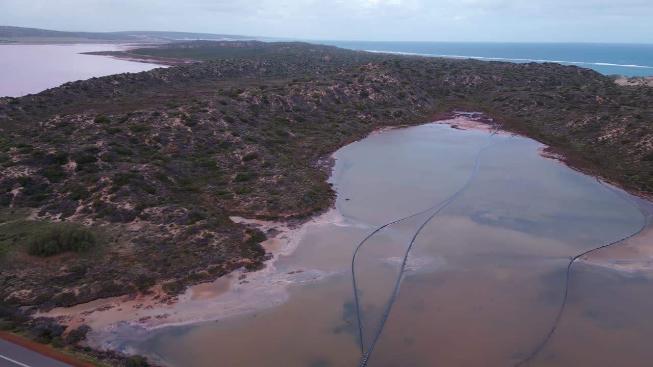 Stunning drone footage panning around the vicinity of the iconic pink lake and port Gregory road which brings visitors to this tourist destination