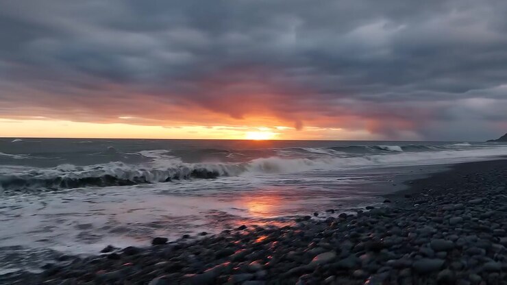 Dramatic Sunset Over Rugged Pebble Beach and Coastal Cliffs