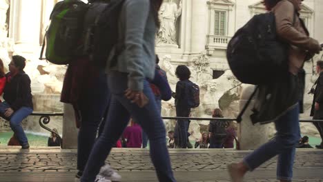 people walking around trevi fountain