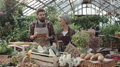 два сотрудника обслуживают покупателей в продуктовом магазине