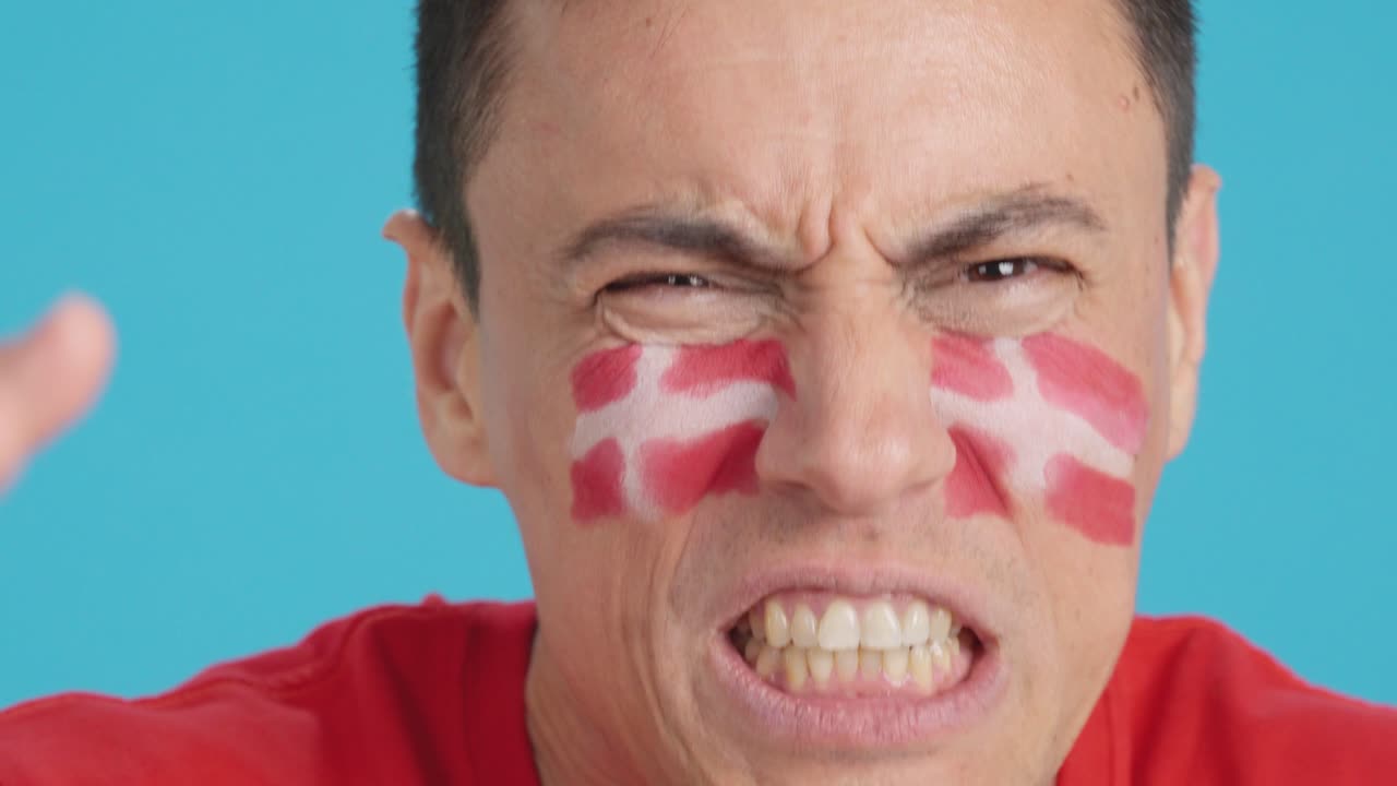 Man with danish national flag upset with a referee