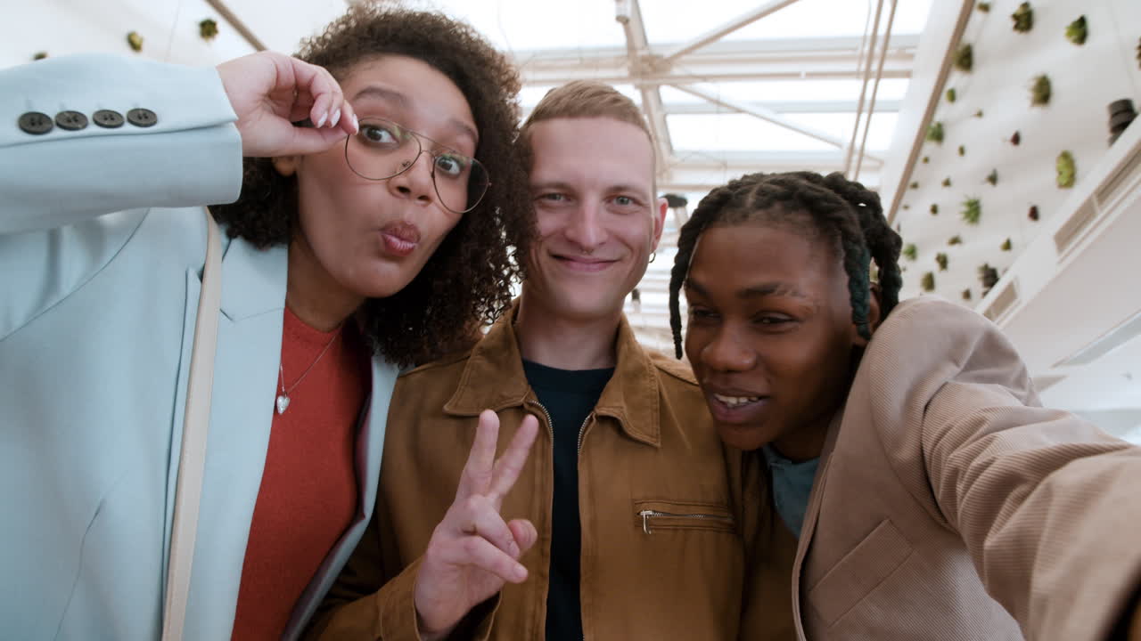 Friends Taking a Selfie in a Modern Shopping Mall