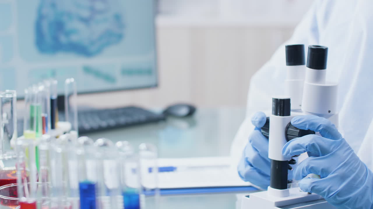 Scientist working in a lab with a microscope