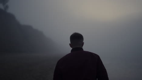 Stylish-guy-enjoying-walk-at-sea-coastline.-Sad-man-looking-ocean-horizon