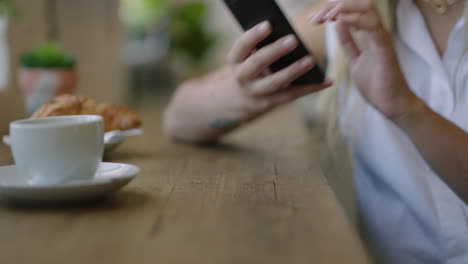 woman-hands-using-smartphone-browsing-online-messages-relaxing-in-coffee-shop-texting-enjoying-mobile-phone-sharing-lifestyle-on-social-media-close-up