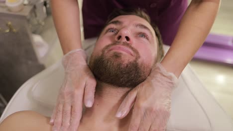 a handsome man having a massage procedure in a spa salon. relaxing massage.