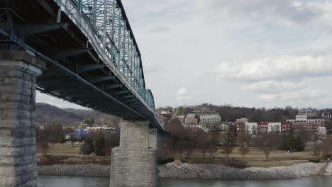 cinematic drone view underneath popular walking bridge in chattanooga, tennessee