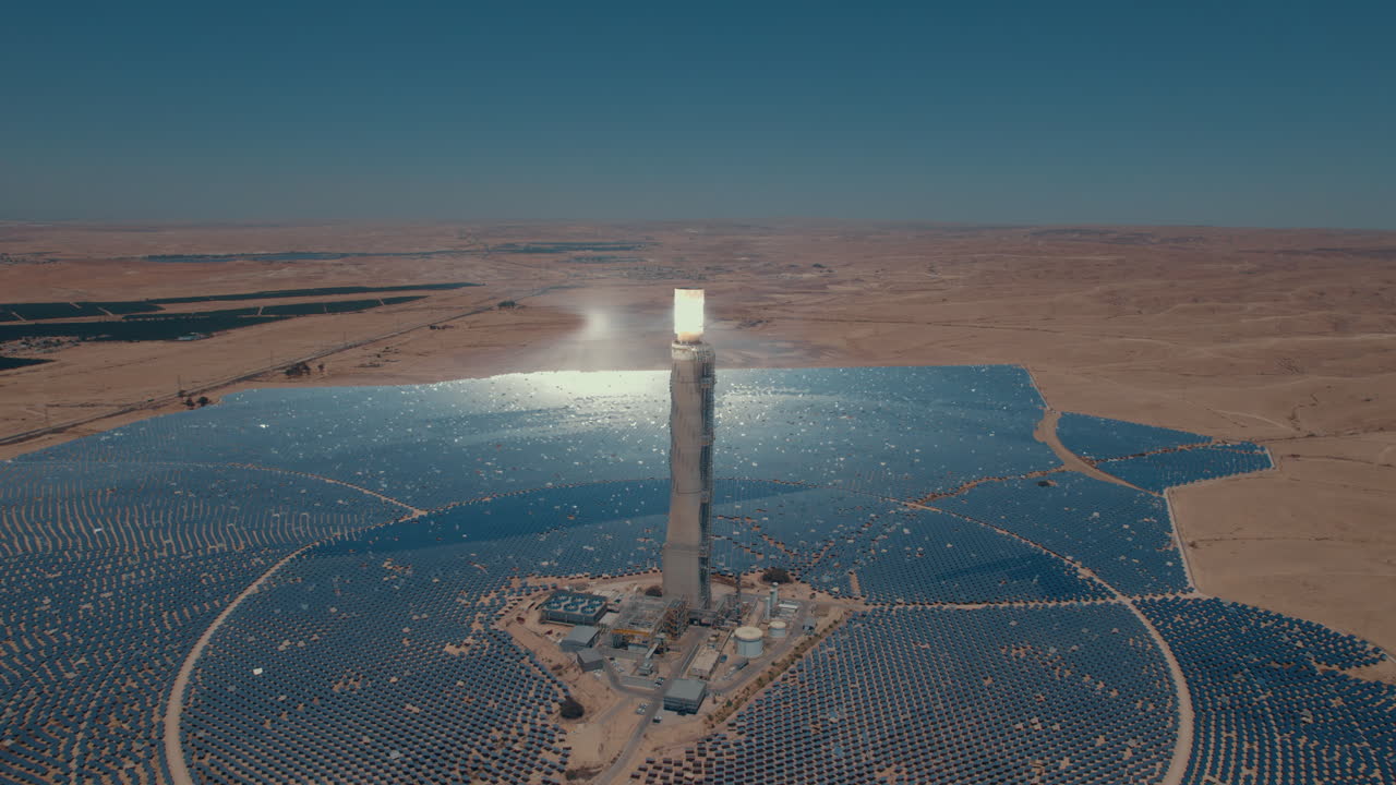 Solar power tower focused sunlight for movable mirrors at the desert sun non time in a cloudless day3- slow tracking drone shot