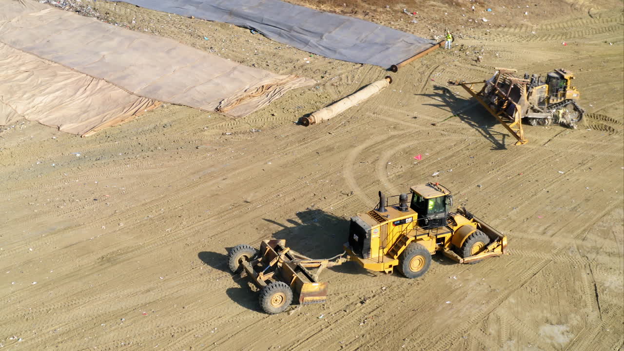Heavy machinery operating at a large earthmoving or landfill site