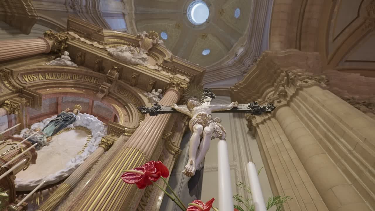 powerful low angle of jesus on crucifix illuminated by golden church altar interior