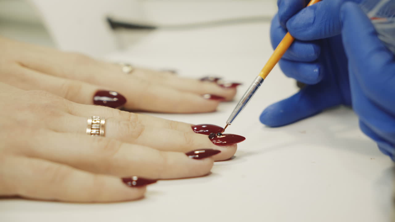 Manicure concept. Professional manicurist glues rhinestones on nails