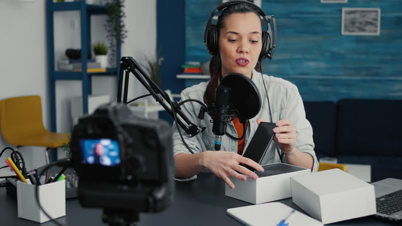 Tech vlogger doing unpacking review video of mobile phone