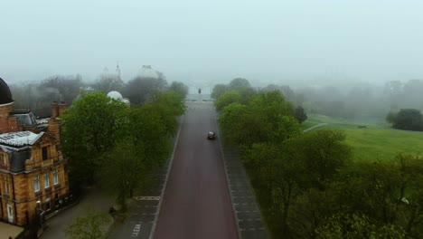 beautiful foggy aerial view of the asphalt road and tree's beside